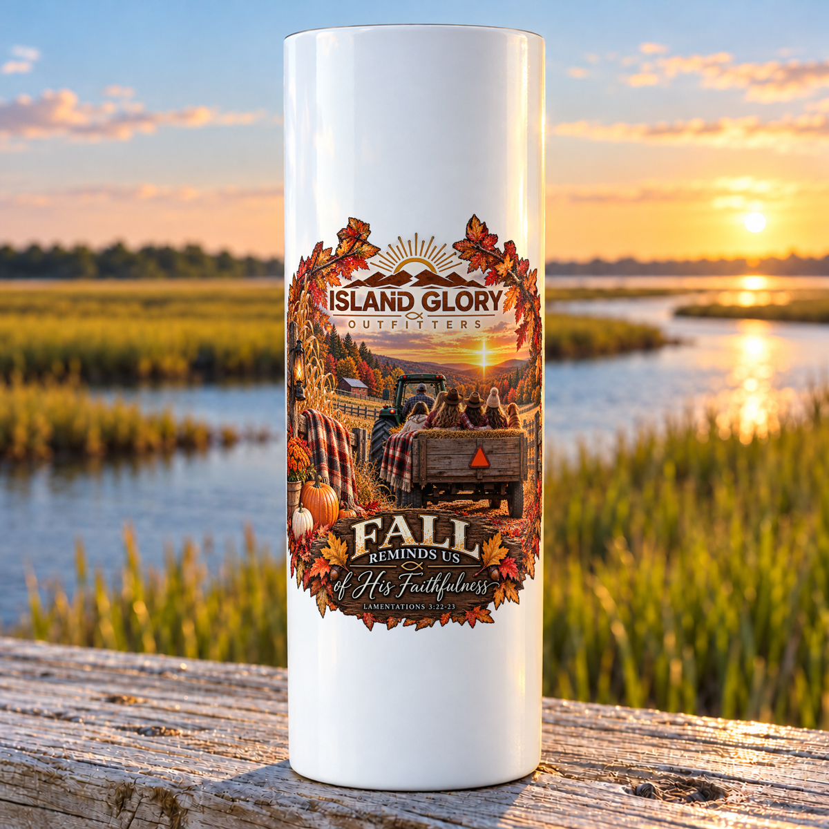 Fall Reminds Us design on a white Hogg 20 oz skinny tumbler beside an Eastern North Carolina coastal marsh.