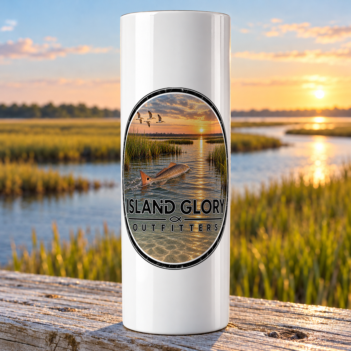 Redfish Marsh design on a white Hogg 20 oz skinny tumbler beside an Eastern North Carolina coastal marsh.