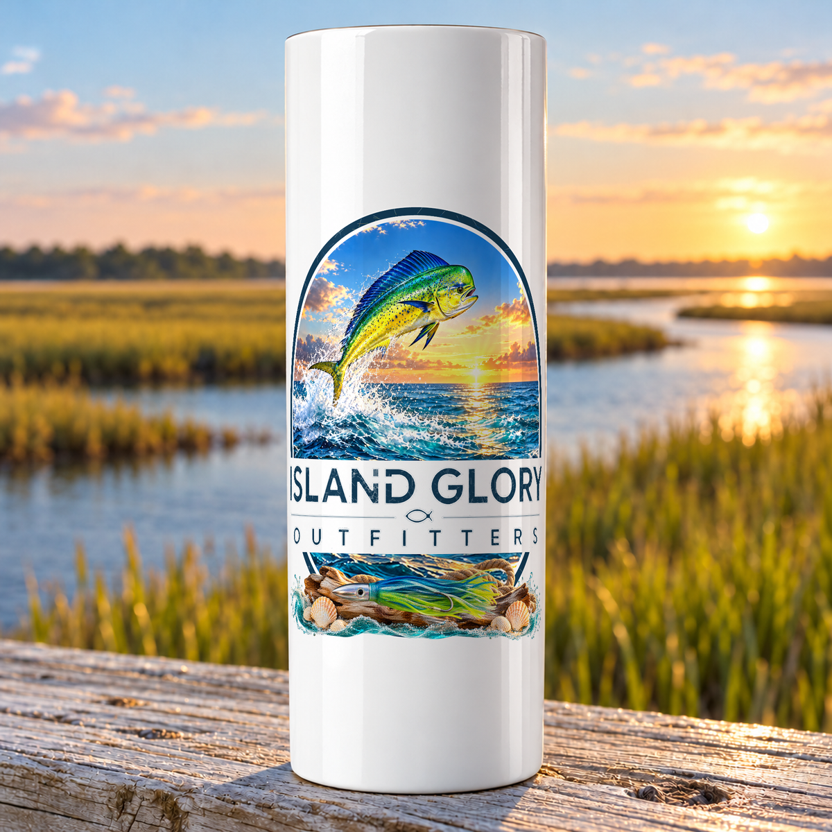 Offshore Mahi design on a white Hogg 20 oz skinny tumbler beside an Eastern North Carolina coastal marsh.