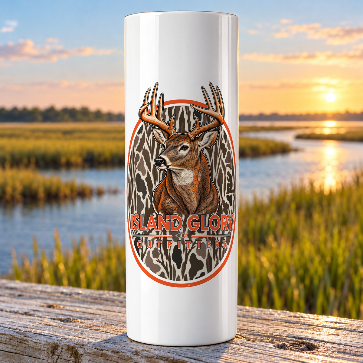 Premium Buck design on a white Hogg 20 oz skinny tumbler beside an Eastern North Carolina coastal marsh.